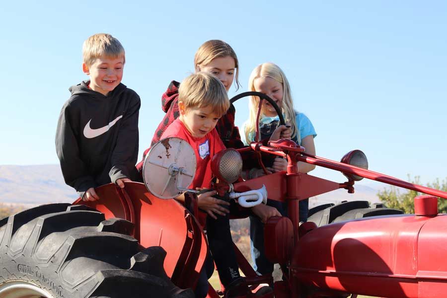 Kids exploring an old farm tractor